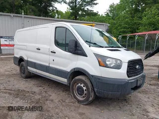2015 Ford Transit Cargo z VIN 1FTYR1ZM9FKA21382, wystawiony jako IAAI lot #42184401 z przebiegiem 163 317 mil mil oraz . Historia ofert i sprzedaży dostępna na DreamBid. Obrazek 1.