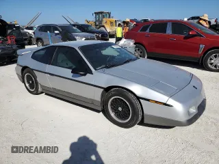 1986 Pontiac Fiero z VIN 1G2PG9799GP261135, wystawiony jako Copart lot #77305934 z przebiegiem 53 837 mil mil oraz Szkody całkowita. Historia ofert i sprzedaży dostępna na DreamBid. Obrazek 4.