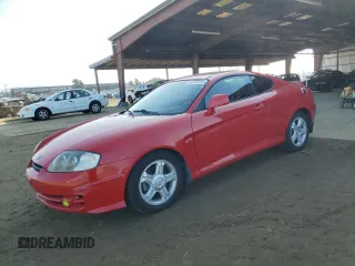 2003 Hyundai Tiburon GT z VIN KMHHN65F63U060104, wystawiony jako Copart lot #84560184 z przebiegiem 160 120 mil mil oraz Czysty tytuł • Clean title. Historia ofert i sprzedaży dostępna na DreamBid. Obrazek 1.