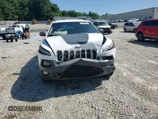 2015 Jeep Cherokee Trailhawk with VIN 1C4PJMBS0FW705288, listed as a Copart auction lot 61796275 with 133,874 mi miles and Salvage title. Bid and sale history available at DreamBid. Image 14.