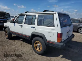 1993 Jeep Cherokee Sport with VIN 1J4FJ68S4PL555701, listed as a Copart auction lot 76020714 with 130,884 mi miles and Salvage Title. Bid and sale history available at carsss.com. Image 2.