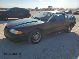 1997 Ford Mustang with VIN 1FALP4043VF174092, listed as a Copart auction lot 86983884 with 105,774 mi miles and Salvage Title. Bid and sale history available at carsss.com. Image 1.