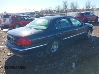 1999 Lincoln Continental with VIN 1LNHM97V8XY700644, listed as a IAAI auction lot 41641082 with 142,527 mi miles. Bid and sale history available at carsss.com. Image 4.
