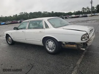 1999 Jaguar XJ with VIN SAJKX6049XC858040, listed as a Copart auction lot 64894604 with 218,054 mi miles and Salvage Title. Bid and sale history available at carsss.com. Image 2.