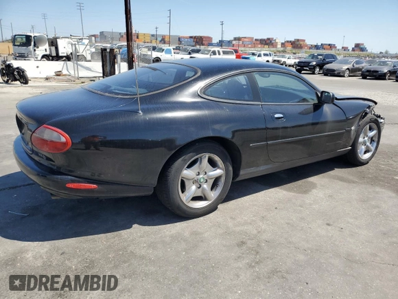 1997 Jaguar XK with VIN SAJGX5740VC014035, listed as a Copart auction lot 53066215 with 140,692 mi miles and Salvage Title. Bid and sale history available at DreamBid. Image 3.
