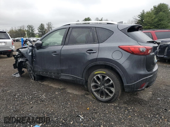 2016 Mazda CX-5 Grand Touring z VIN JM3KE2DY9G0687261, wystawiony jako Copart lot #52865415 z przebiegiem Nie podano mil oraz Szkoda całkowita • Salvage title. Historia ofert i sprzedaży dostępna na DreamBid. Obrazek 2.