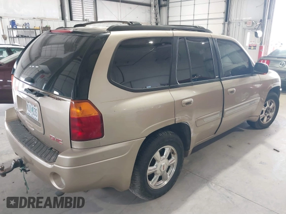 2004 GMC Envoy SLE with VIN 1GKDT13S442136464, listed as a IAAI auction lot 41874304 with 250,330 mi miles. Bid and sale history available at carsss.com. Image 4.
