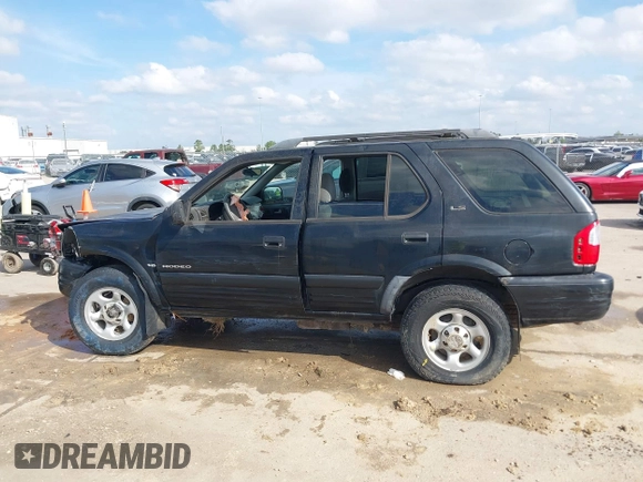 2001 Isuzu Rodeo S with VIN 4S2CK58W114363340, listed as a IAAI auction lot 41498698 with 185,408 mi miles and . Bid and sale history available at DreamBid. Image 14.