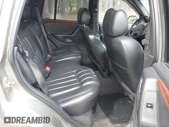 1999 Jeep Grand Cherokee Limited with VIN 1J4GW68N5XC684157, listed as a IAAI auction lot 42104283 with 164,506 mi miles. Bid and sale history available at carsss.com. Image 8.