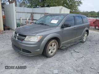 2013 Dodge Journey SE z VIN 3C4PDCAB2DT577805, wystawiony jako IAAI lot #41674351 z przebiegiem 183 006 mil mil oraz . Historia ofert i sprzedaży dostępna na DreamBid. Obrazek 2.