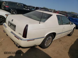 2000 Cadillac Eldorado z VIN 1G6EL12Y2YU179560, wystawiony jako Copart lot #70635784 z przebiegiem 92 959 mil mil oraz Tytuł czysty. Historia ofert i sprzedaży dostępna na DreamBid. Obrazek 3.