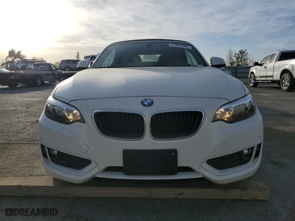 2015 BMW 2 Series 228i with VIN WBA1K5C57FV242909, listed as a Copart auction lot 77490994 with 55,099 mi miles and Salvage Title. Bid and sale history available at carsss.com. Image 5.