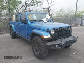 2023 Jeep Gladiator Sport S z VIN 1C6HJTAG6PL579136, wystawiony jako IAAI lot #41946641 z przebiegiem 14 856 mil mil oraz . Historia ofert i sprzedaży dostępna na DreamBid. Obrazek 1.