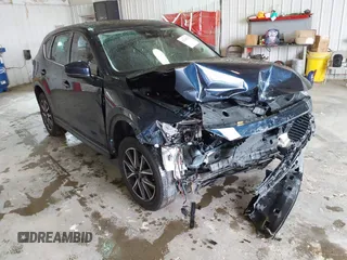 2018 Mazda CX-5 Grand Touring with VIN JM3KFBDM0J0326812, listed as a IAAI auction lot 42145373 with 122,535 mi miles and . Bid and sale history available at DreamBid. Image 1.