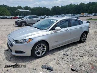 2015 Ford Fusion SE Hybrid z VIN 3FA6P0LU4FR301714, wystawiony jako Copart lot #64370525 z przebiegiem 174 076 mil mil oraz Czysty tytuł • Clean title. Historia ofert i sprzedaży dostępna na DreamBid. Obrazek 1.