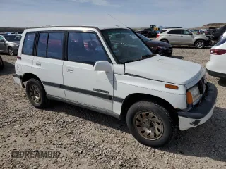 1995 Suzuki Sidekick z VIN JS3TD03V4S4113472, wystawiony jako Copart lot #51279074 z przebiegiem 199 736 mil mil oraz Tytuł czysty. Historia ofert i sprzedaży dostępna na DreamBid. Obrazek 4.