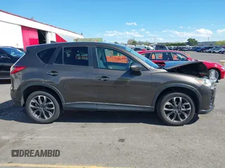 2016 Mazda CX-5 Grand Touring with VIN JM3KE2DYXG0773663, listed as a IAAI auction lot 41896367 with 86,571 mi miles and . Bid and sale history available at DreamBid. Image 14.