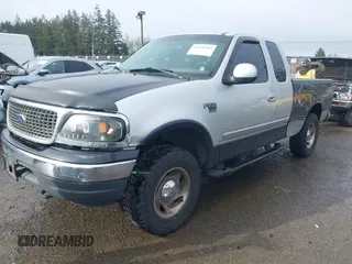 2000 Ford F-150 XL z VIN 1FTRX18L8YKA72409, wystawiony jako IAAI lot #41928360 z przebiegiem 167 251 mil mil oraz . Historia ofert i sprzedaży dostępna na DreamBid. Obrazek 2.
