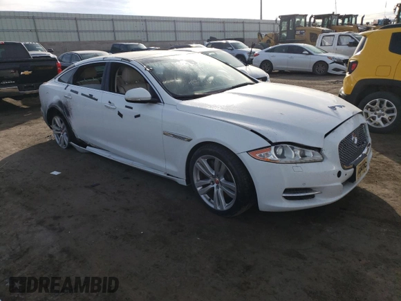 2014 Jaguar XJ with VIN SAJWA2GZ7E8V69543, listed as a Copart auction lot 86390204 with 110,929 mi miles and Salvage Title. Bid and sale history available at carsss.com. Image 4.