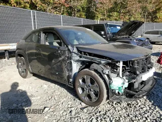 2023 Mazda MX-30 Premium Plus Package with VIN JM1DRADBXP0200211, listed as a Copart auction lot 77109834 with 10,778 mi miles and Salvage Title. Bid and sale history available at carsss.com. Image 4.