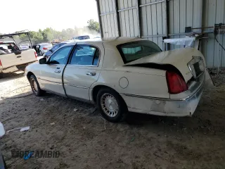 1999 Lincoln Town Car Executive with VIN 1LNHM81W2XY658371, listed as a Copart auction lot 60249045 with 191,266 mi miles and Salvage title. Bid and sale history available at DreamBid. Image 2.