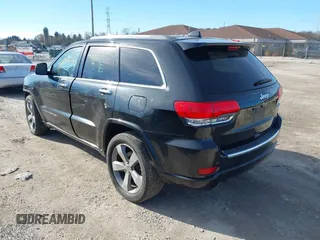 2014 Jeep Grand Cherokee Overland with VIN 1C4RJECG4EC523747, listed as a IAAI auction lot 40802143 with 124,079 mi miles. Bid and sale history available at carsss.com. Image 3.