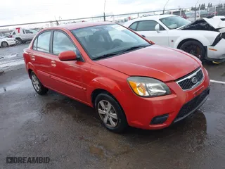 2011 Kia Rio LX with VIN KNADH4A35B6714486, listed as a IAAI auction lot 41795781 with 157,354 mi miles. Bid and sale history available at carsss.com. Image 1.