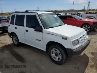 1996 Geo Tracker z VIN 2CNBE1364T6909947, wystawiony jako Copart lot #54411835 z przebiegiem 171 862 mil mil oraz Szkody całkowita. Historia ofert i sprzedaży dostępna na DreamBid. Obrazek 4.