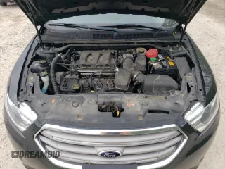 2013 Ford Taurus SEL z VIN 1FAHP2H84DG102036, wystawiony jako Copart lot #57772285 z przebiegiem 156 609 mil mil oraz Czysty tytuł • Clean title. Historia ofert i sprzedaży dostępna na DreamBid. Obrazek 11.