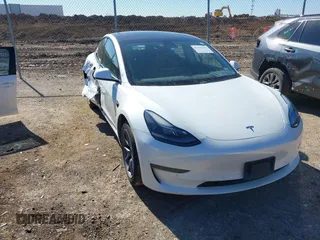 2021 Tesla Model 3 Standard Range Plus z VIN 5YJ3E1EA4MF053720, wystawiony jako IAAI lot #41431363 z przebiegiem 62 761 mil mil oraz . Historia ofert i sprzedaży dostępna na DreamBid. Obrazek 1.