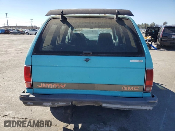 1991 GMC Jimmy z VIN 1GKCS13Z2M2518231, wystawiony jako Copart lot #64115274 z przebiegiem 132 698 mil mil oraz Czysty tytuł • Clean title. Historia ofert i sprzedaży dostępna na DreamBid. Obrazek 6.
