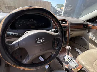 2005 Hyundai XG z VIN KMHFU45E95A381631, wystawiony jako Copart lot #57705005 z przebiegiem 202 730 mil mil oraz Tytuł czysty. Historia ofert i sprzedaży dostępna na DreamBid. Obrazek 9.