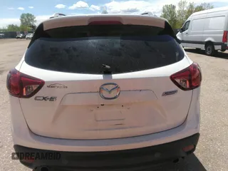 2014 Mazda CX-5 Touring with VIN JM3KE2CY7E0364311, listed as a IAAI auction lot 42108176 with 90,506 mi miles and . Bid and sale history available at DreamBid. Image 16.