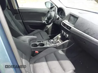 2016 Mazda CX-5 Touring z VIN JM3KE2CY3G0728968, wystawiony jako IAAI lot #42189174 z przebiegiem 145 977 mil mil oraz . Historia ofert i sprzedaży dostępna na DreamBid. Obrazek 5.