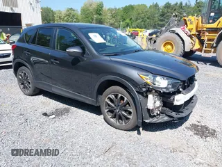 2016 Mazda CX-5 Grand Touring z VIN JM3KE4DY6G0900761, wystawiony jako IAAI lot #42400566 z przebiegiem 95 326 mil mil oraz . Historia ofert i sprzedaży dostępna na DreamBid. Obrazek 1.
