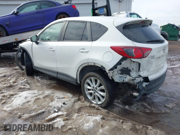 2014 Mazda CX-5 Grand Touring with VIN JM3KE4DY9E0300491, listed as a IAAI auction lot 41657153 with 157,394 mi miles and . Bid and sale history available at DreamBid. Image 3.