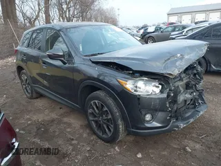 2016 Mazda CX-5 Grand Touring z VIN JM3KE4DYXG0684638, wystawiony jako IAAI lot #41101563 z przebiegiem 130 401 mil mil oraz . Historia ofert i sprzedaży dostępna na DreamBid. Obrazek 1.