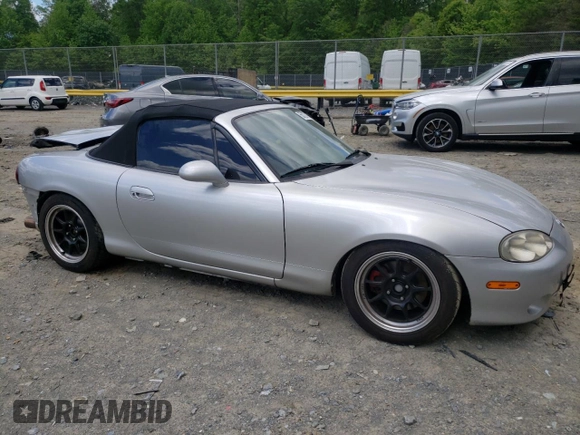 2004 Mazda MX-5 Miata LS with VIN JM1NB353640400140, listed as a Copart auction lot 56127165 with 123,276 mi miles and Salvage title. Bid and sale history available at DreamBid. Image 4.