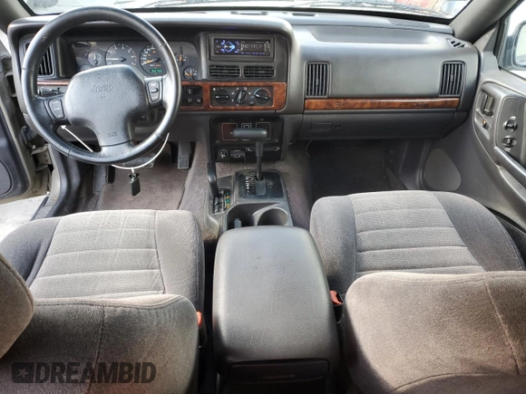 1996 Jeep Grand Cherokee Laredo with VIN 1J4GZ58S3TC245928, listed as a Copart auction lot 57313735 with 165,733 mi miles and Salvage title. Bid and sale history available at DreamBid. Image 8.