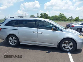 2011 Honda Odyssey Touring with VIN 5FNRL5H99BB058448, listed as a IAAI auction lot 42651432 with 208,581 mi miles and . Bid and sale history available at DreamBid. Image 13.