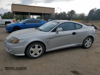 2003 Hyundai Tiburon GT z VIN KMHHN65F13U013420, wystawiony jako Copart lot #51234495 z przebiegiem 230 612 mil mil oraz Szkoda całkowita • Salvage title. Historia ofert i sprzedaży dostępna na DreamBid. Obrazek 1.