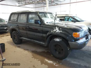 1997 Toyota Land Cruiser with VIN JT3HJ85J1V0184599, listed as a IAAI auction lot 41571386 with 305,201 mi miles. Bid and sale history available at carsss.com. Image 1.