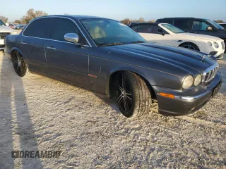 2004 Jaguar XJ with VIN SAJEA74C24SG09038, listed as a Copart auction lot 77015544 with Not Provided miles and Salvage Title. Bid and sale history available at DreamBid. Image 4.