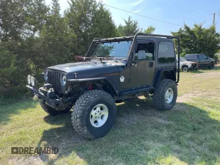 1999 Jeep Wrangler Sahara with VIN 1J4FY49S5XP496486, listed as a Copart auction lot 77263014 with 128,498 mi miles and Clean Title. Bid and sale history available at carsss.com. Image 2.