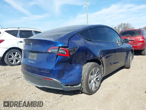 2021 Tesla Model Y Standard Range z VIN 5YJYGDED6MF107711, wystawiony jako IAAI lot #41794384 z przebiegiem 86 934 mil mil oraz . Historia ofert i sprzedaży dostępna na DreamBid. Obrazek 4.