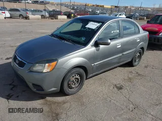 2010 Kia Rio LX with VIN KNADH4A34A6674027, listed as a IAAI auction lot 41804686 with 113,528 mi miles. Bid and sale history available at carsss.com. Image 2.