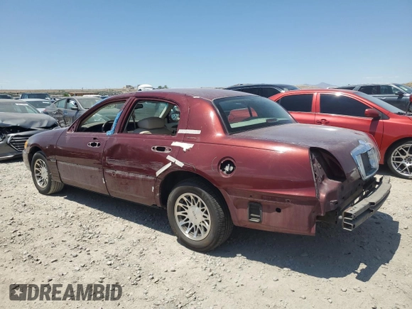 2000 Lincoln Town Car Signature with VIN 1LNHM82W2YY809189, listed as a Copart auction lot 59812665 with 148,236 mi miles and Salvage title. Bid and sale history available at DreamBid. Image 2.
