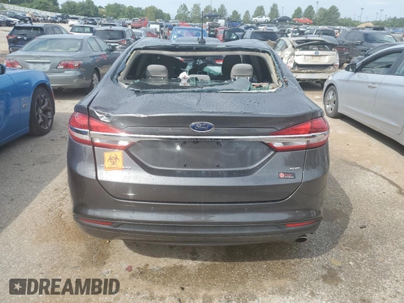 2018 Ford Fusion SE z VIN 3FA6P0H78JR261102, wystawiony jako Copart lot #69963883 z przebiegiem 120 068 mil mil oraz Czysty tytuł • Clean title. Historia ofert i sprzedaży dostępna na DreamBid. Obrazek 6.