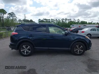 2018 Toyota RAV4 XLE with VIN JTMWFREV9JJ165655, listed as a IAAI auction lot 42138998 with 123,569 mi miles and . Bid and sale history available at carsss.com. Image 13.