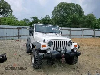 2000 Jeep Wrangler Sahara with VIN 1J4FA59SXYP760278, listed as a Copart auction lot 60402485 with 192,161 mi miles and Salvage title. Bid and sale history available at DreamBid. Image 14.